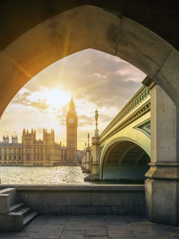 Big Ben with sun through the pedestrian tunnel View of Big Ben and sun through the pedestrian tunnel at sunset, London.